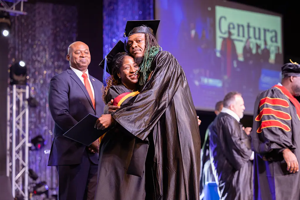 A Centura College instructor and graduate looking to the camera and smiling