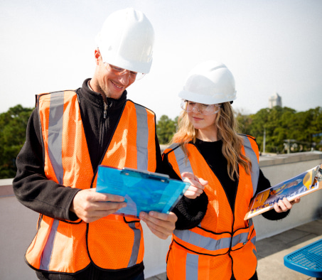 Two Centura College solar technician students reviewing plans for solar panels