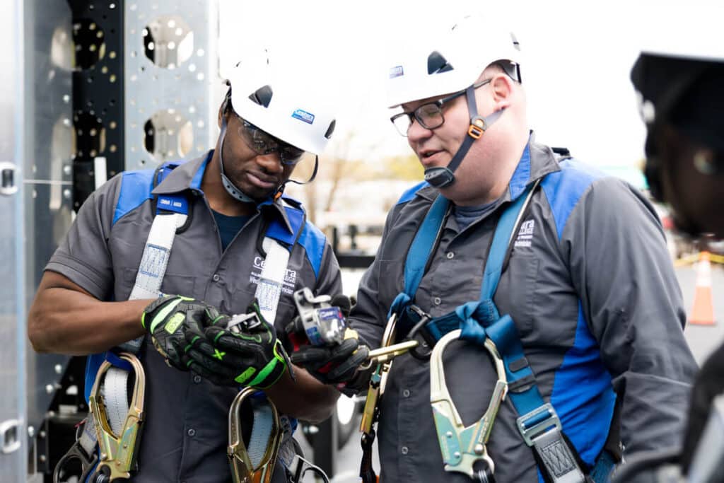 Centura College Wind Turbine Technician Student and Instructor Preparing to Climb