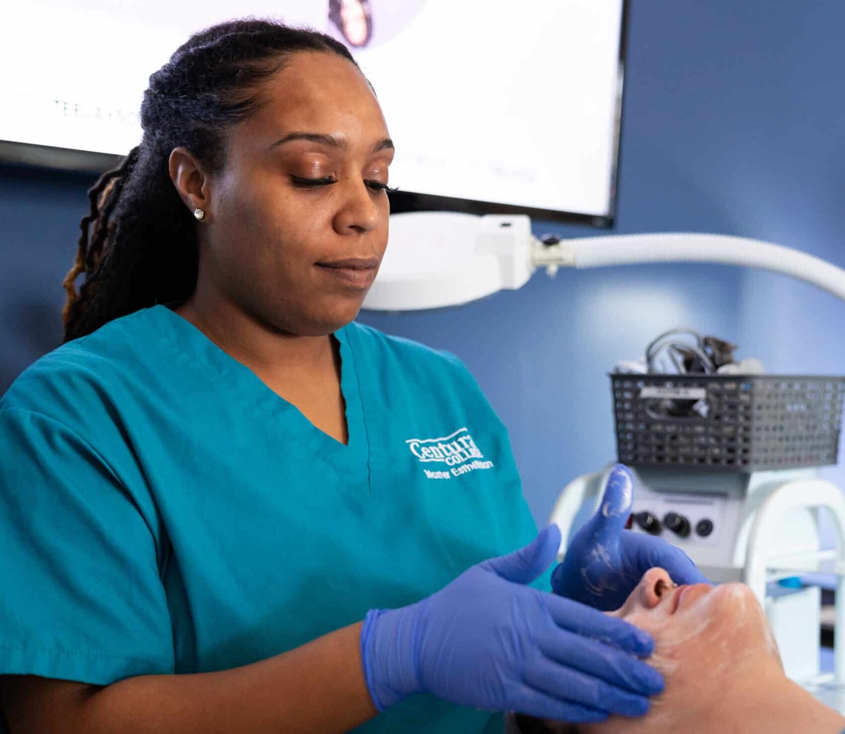 Centura College esthetician program student practicing skin care
