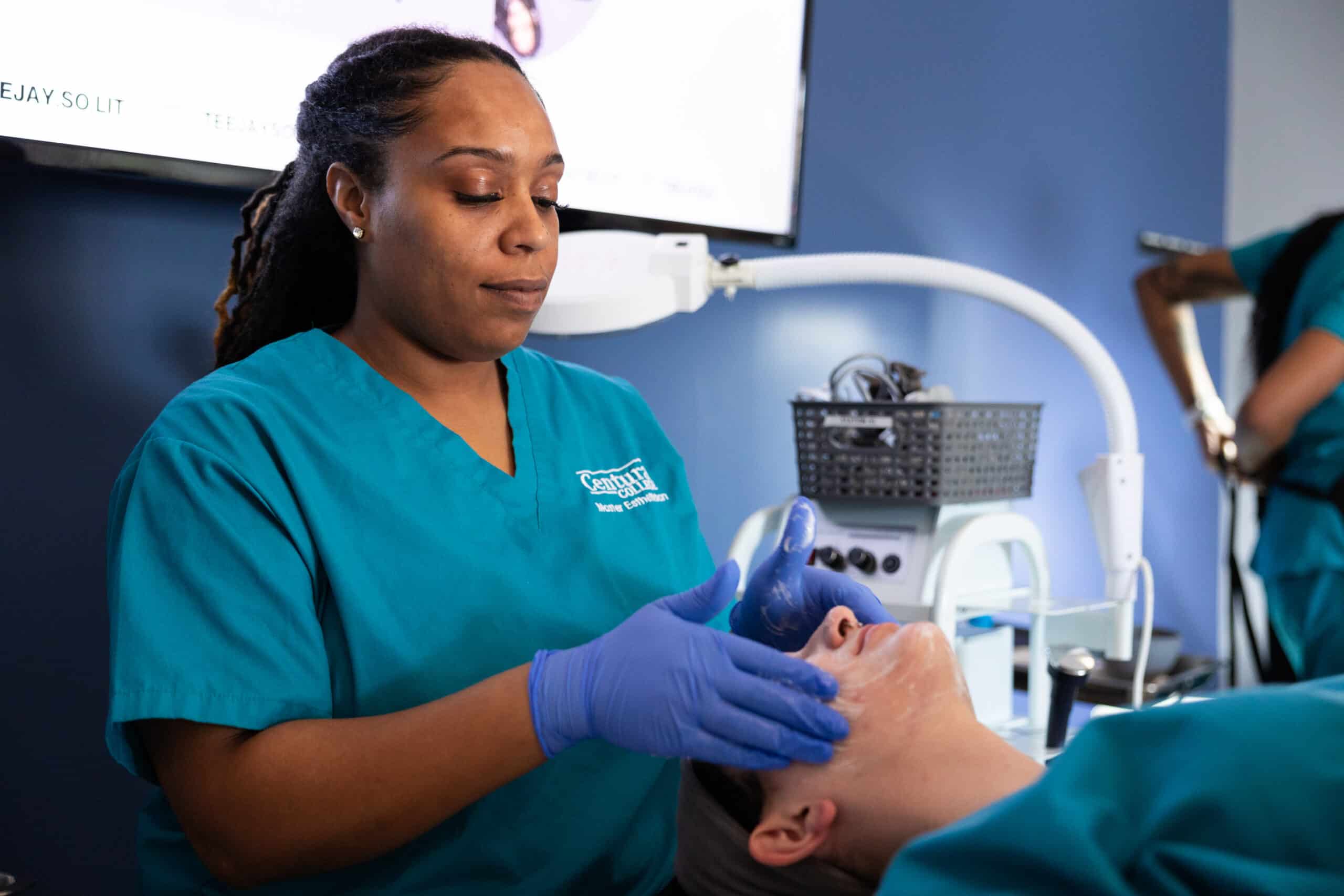 Centura College esthetician program student practicing skin care