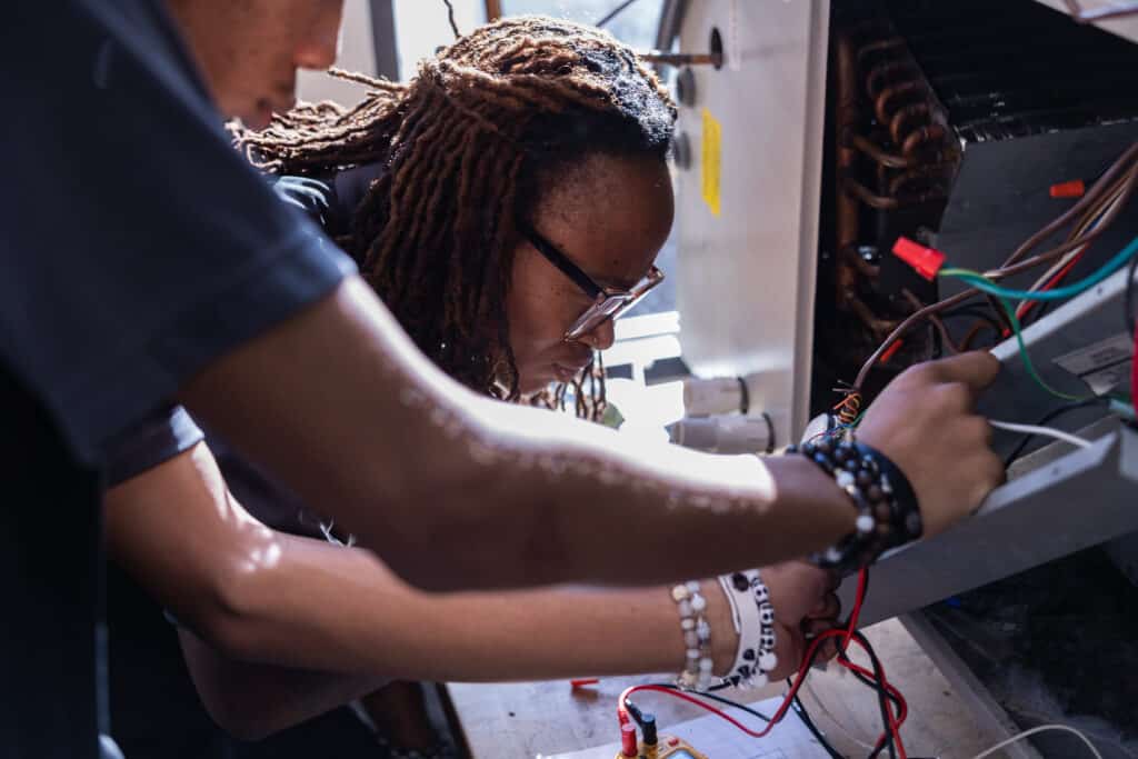 Centura College HVAC student learning HVAC system installation