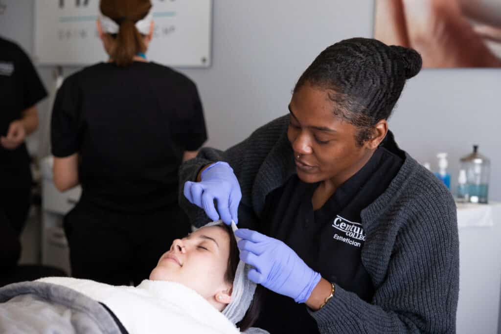 Centura College esthetician student performing a facial treatment